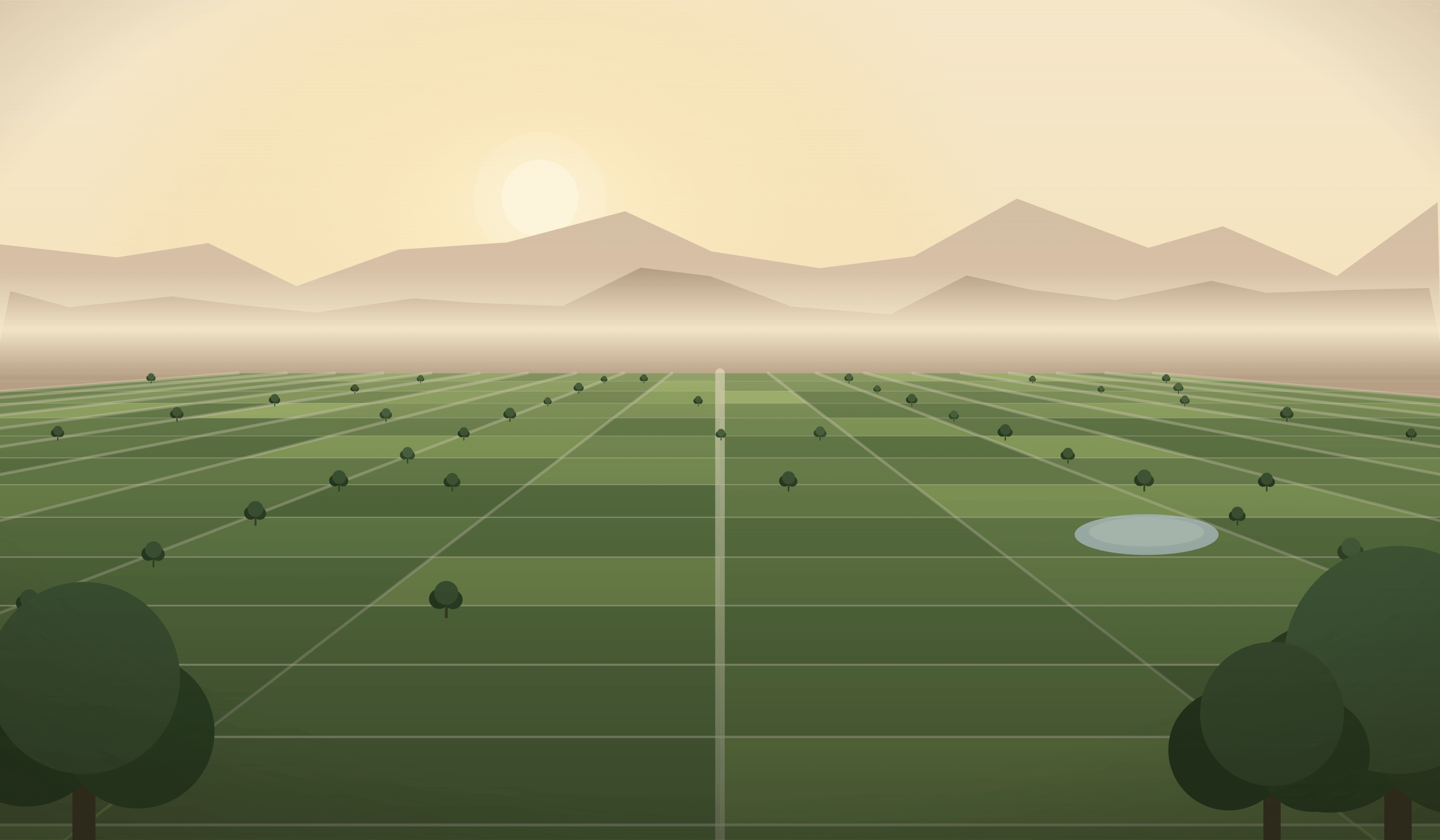 Golden-hour view over plotted green land with tree-lined roads and mountains